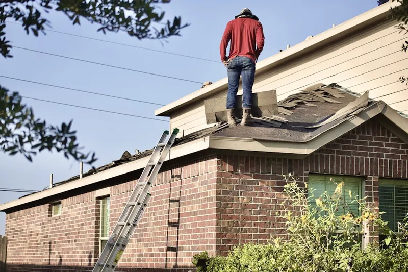 Professional roofer working on a residential roof in Orange Park Acres
